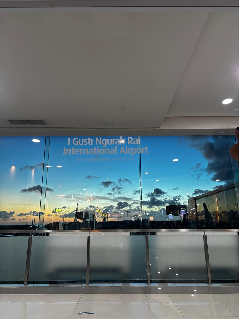I Gusti Ngurah Rai airport gate at sunset through the window