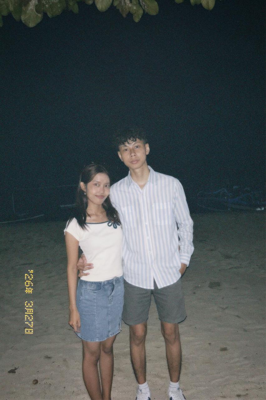 Couple on the beach at night, film-camera datestamp